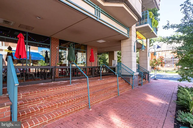 a view of a patio with dining table and chairs and potted plants