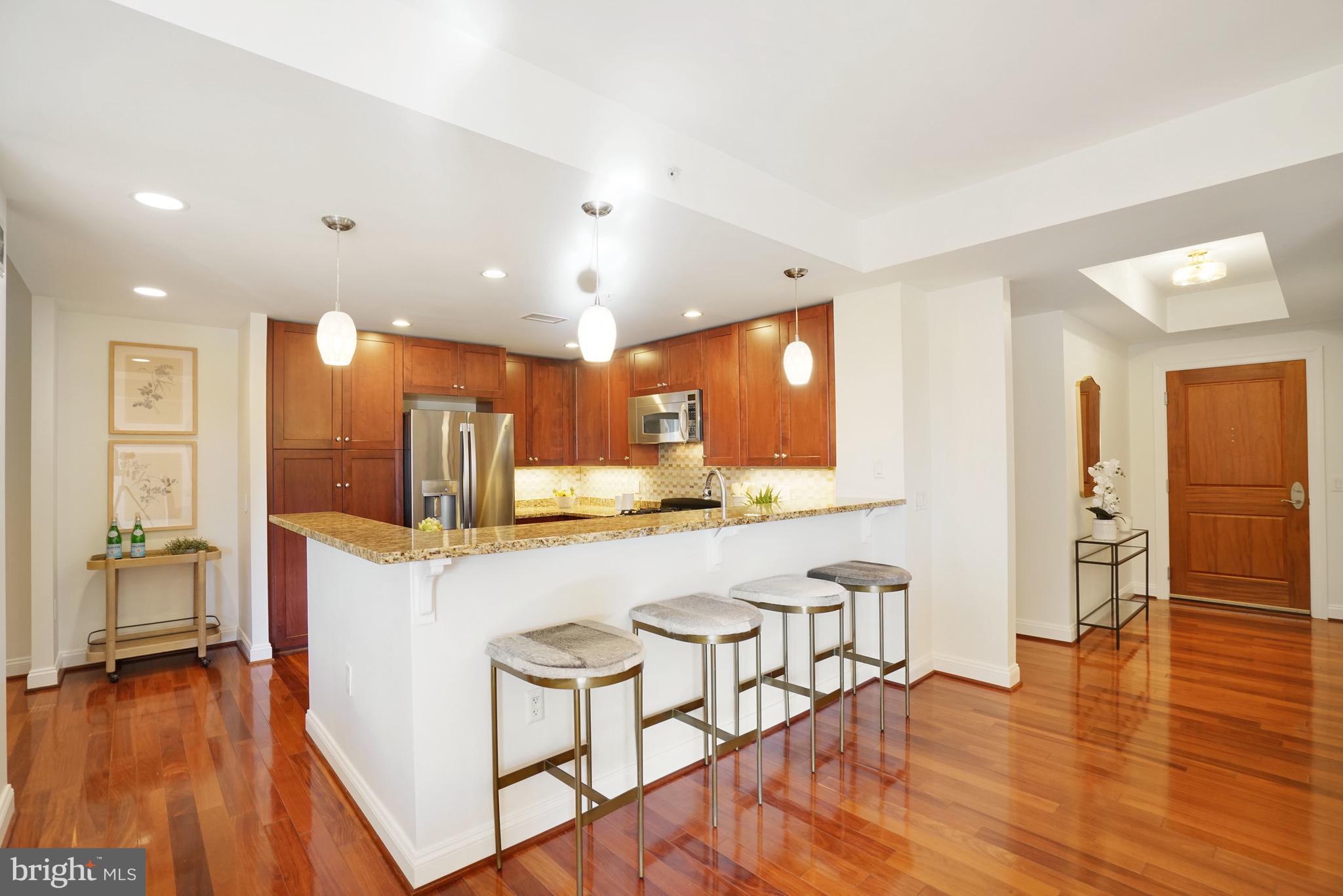 513 West Broad Street, Unit 510 Falls Church, VA 22046 - Photo 5 of 55 a kitchen with stainless steel appliances a refrigerator and wooden floor