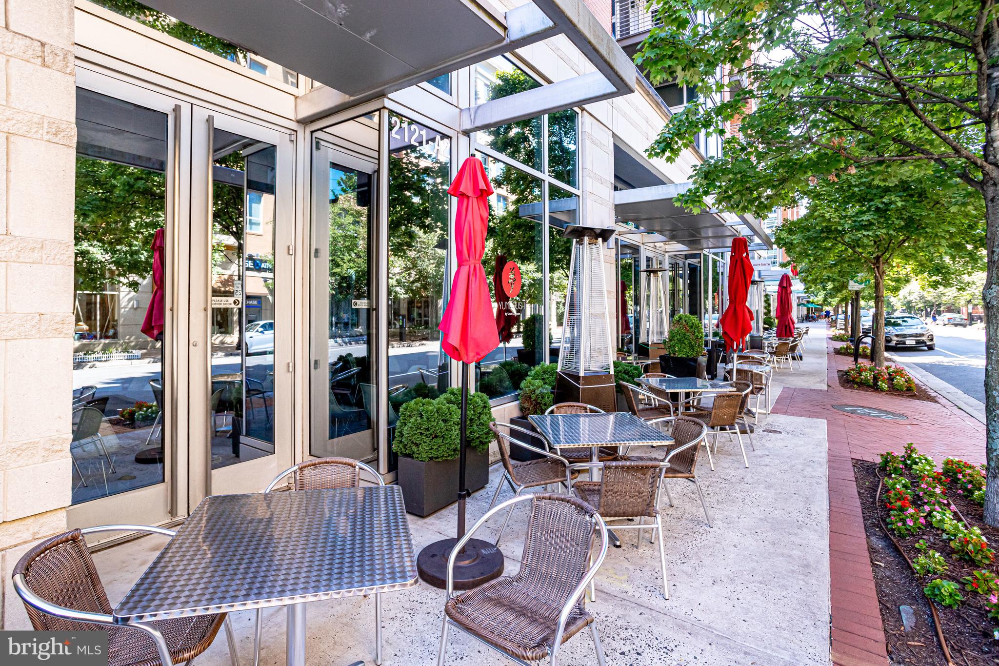513 West Broad Street, Unit 510 Falls Church, VA 22046 - Photo 53 of 55 a view of a patio with dining table and chairs and potted plants