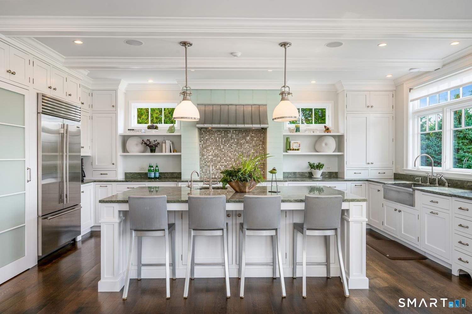 30 Shipway Road Darien, CT 06820 - Photo 12 of 40 a kitchen with stainless steel appliances granite countertop a table and chairs in it