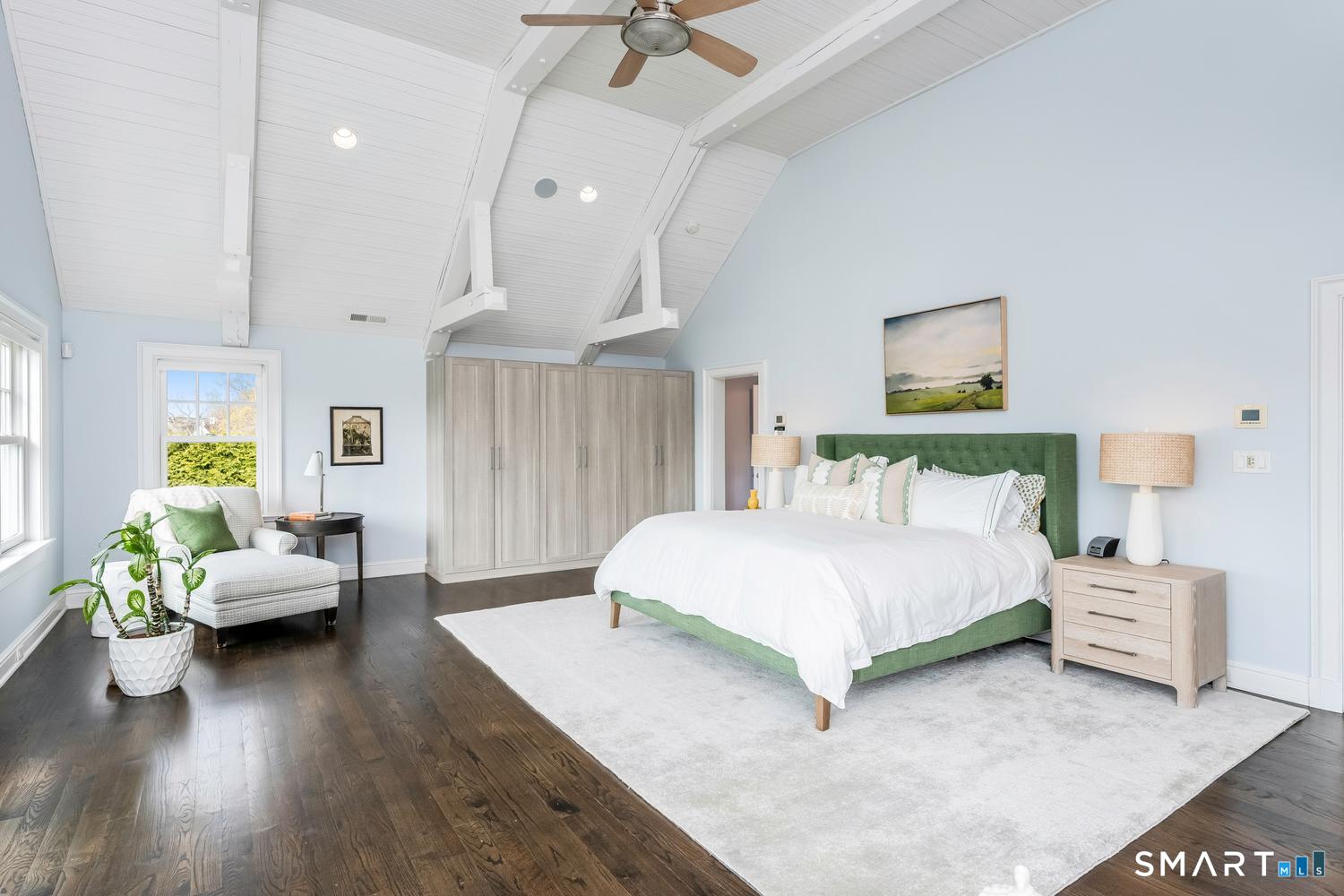 30 Shipway Road Darien, CT 06820 - Photo 17 of 40 a spacious bedroom with a bed couch and a ceiling fan