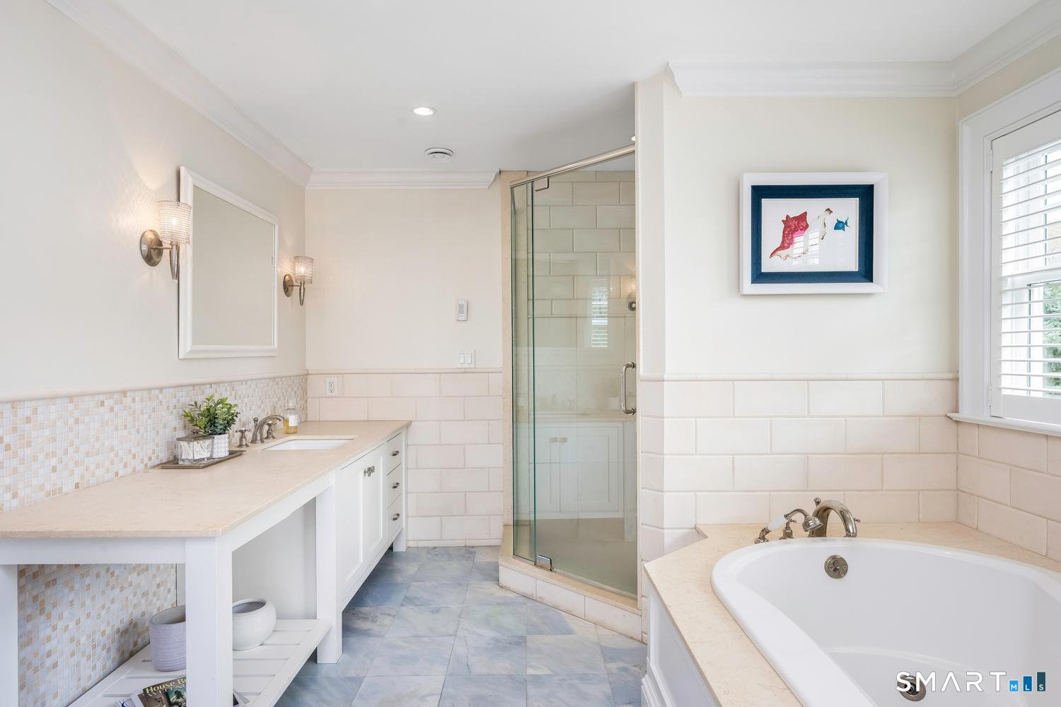 30 Shipway Road Darien, CT 06820 - Photo 20 of 40 a bathroom with a tub sink and mirror