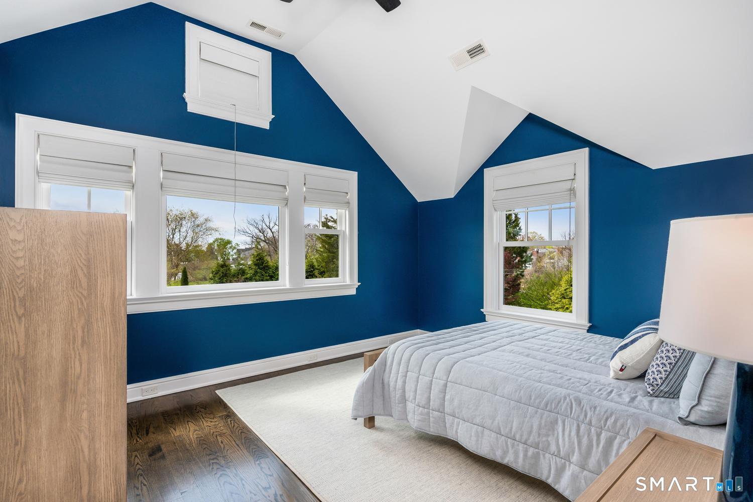 30 Shipway Road Darien, CT 06820 - Photo 21 of 40 a bedroom with a bed and a painting on the wall
