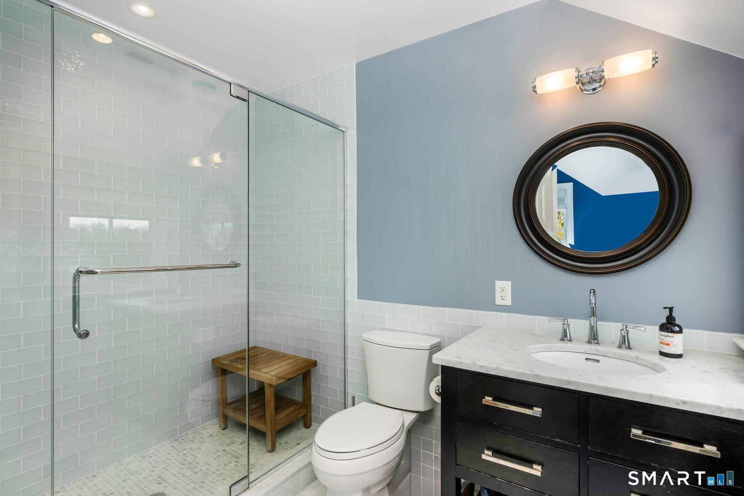 30 Shipway Road Darien, CT 06820 - Photo 22 of 40 a bathroom with a sink a toilet and a mirror