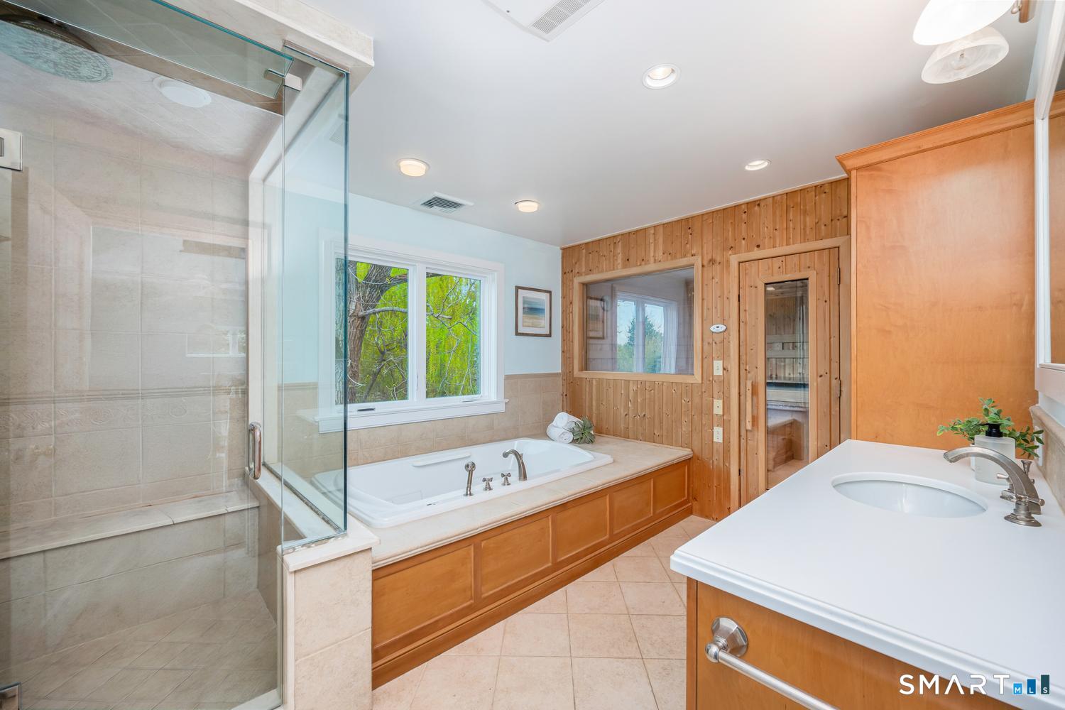 30 Shipway Road Darien, CT 06820 - Photo 33 of 40 a bathroom with a tub sink and mirror