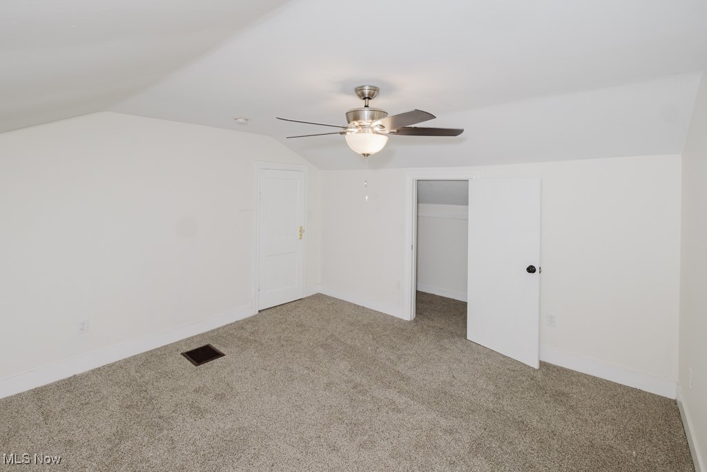 8150 Madison Road Thompson, OH 44086 - Photo 19 of 28 Unfurnished bedroom with vaulted ceiling, carpet floors, and a ceiling fan