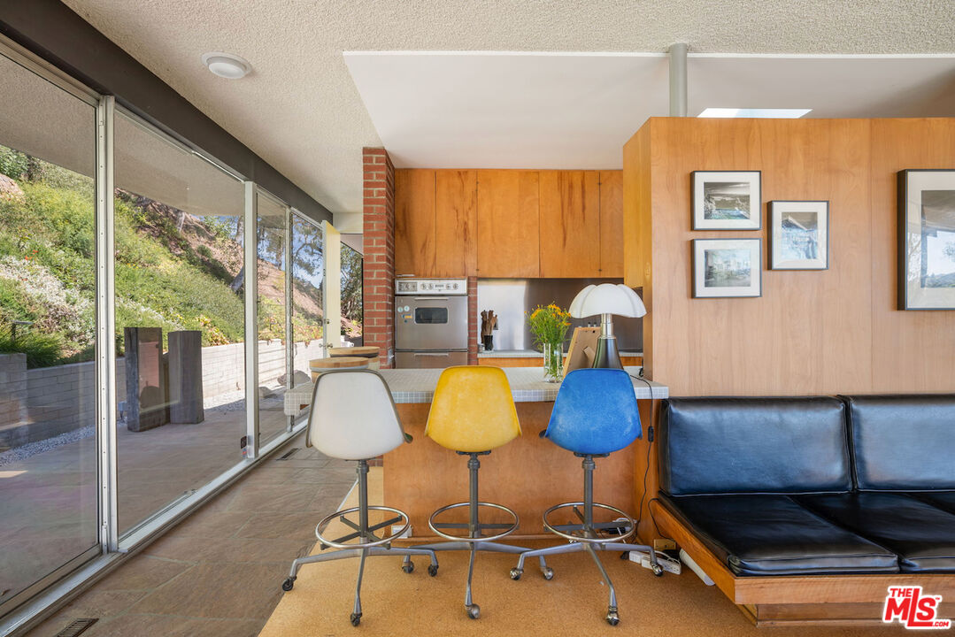 1531 North Tigertail Road Los Angeles, CA 90049 - Photo 19 of 24 a living room with furniture and floor to ceiling window