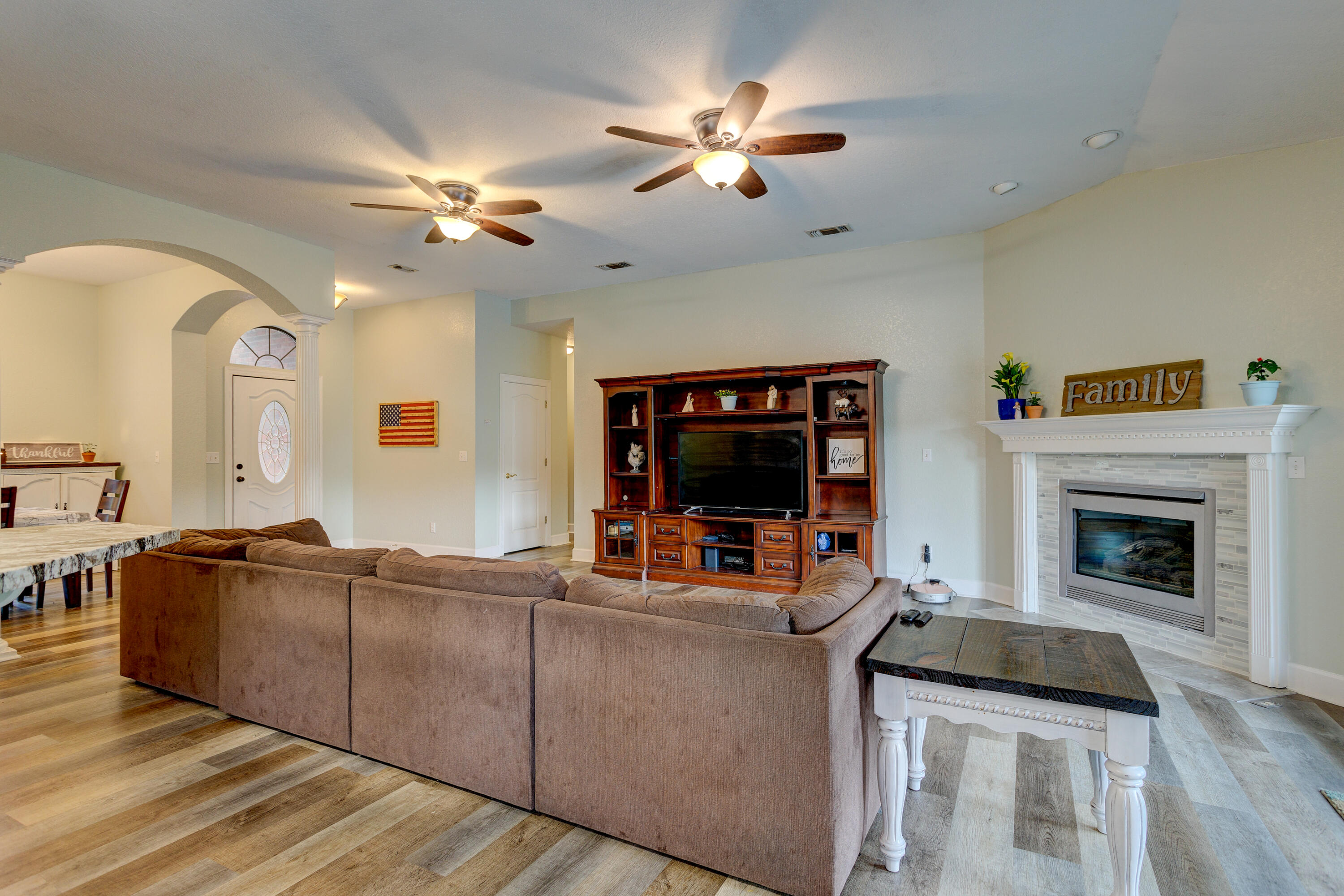 534 Ridge Lake Road Crestview, FL 32536 - Photo 8 of 61 a living room with furniture a flat screen tv and a fireplace