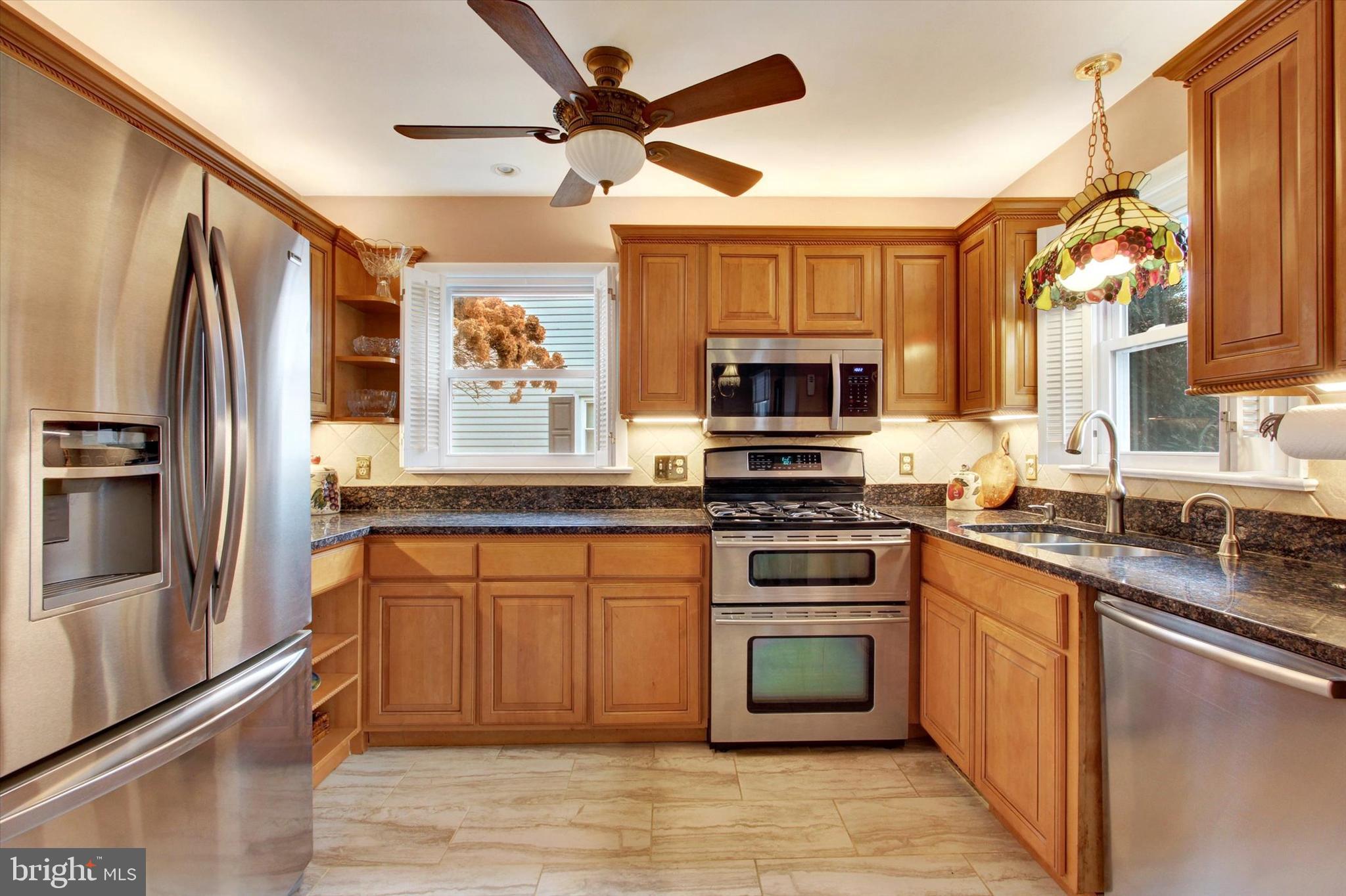 428 George Street Hanover, PA 17331 - Photo 14 of 43 a kitchen with stainless steel appliances granite countertop a refrigerator a stove a sink and a microwave