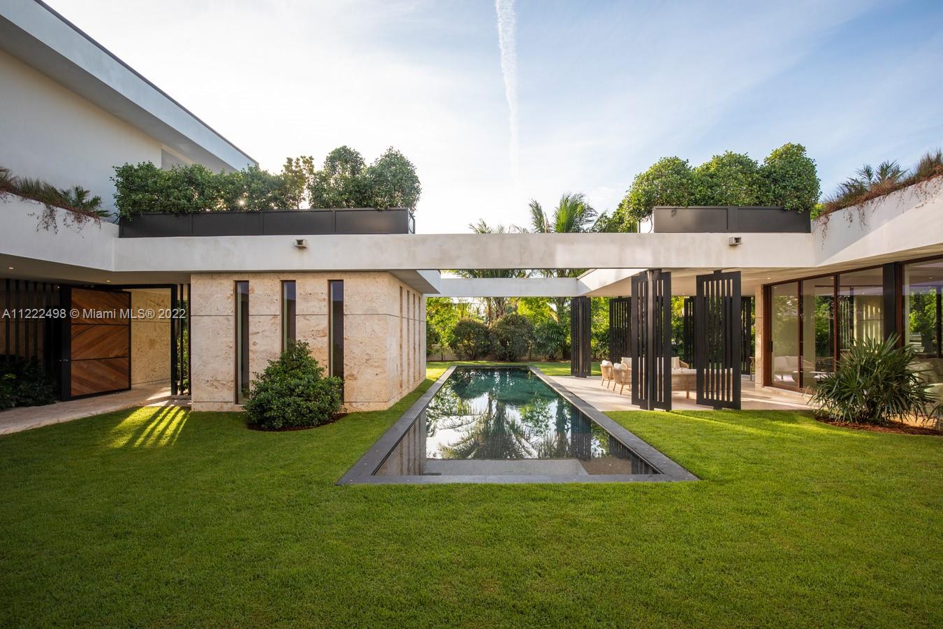 4550 Bay Point Road Miami, FL 33137 - Photo 11 of 92 a view of a house with a yard patio and swimming pool