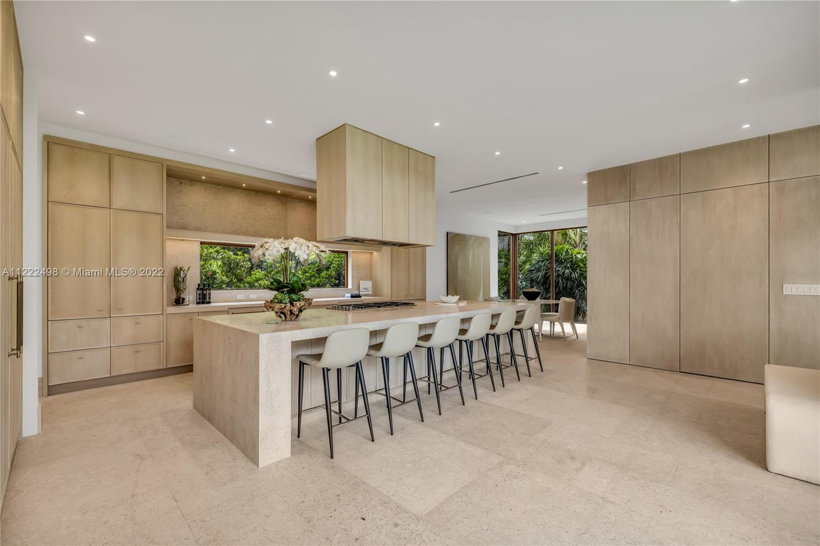 4550 Bay Point Road Miami, FL 33137 - Photo 31 of 92 a large white kitchen with lots of counter space and windows