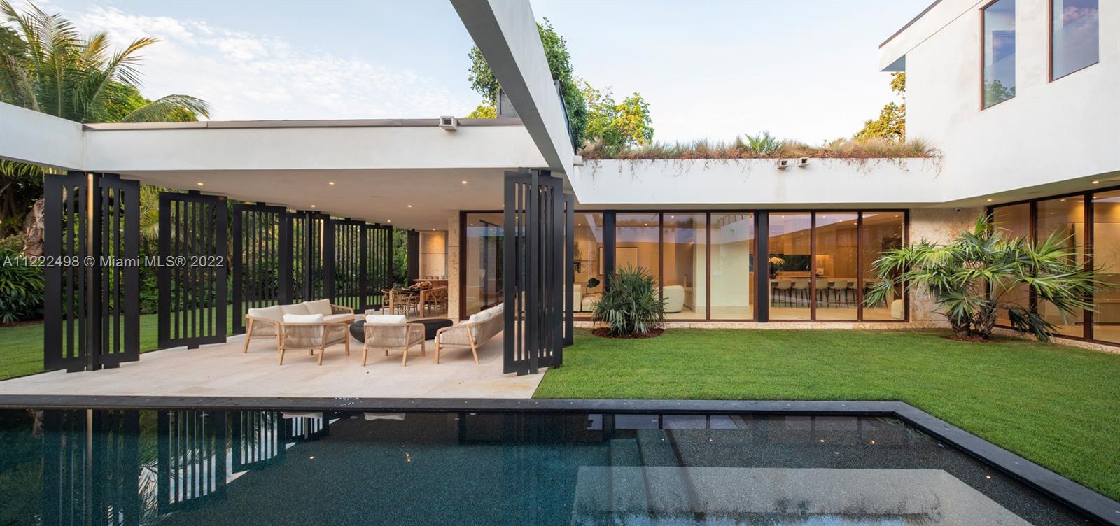 4550 Bay Point Road Miami, FL 33137 - Photo 40 of 92 a view of a house with backyard and sitting area