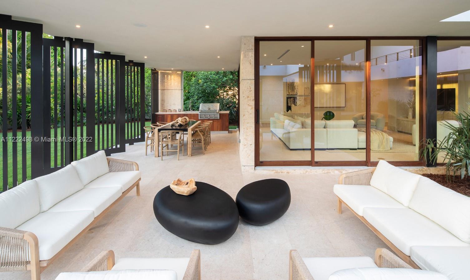 4550 Bay Point Road Miami, FL 33137 - Photo 44 of 92 a living room with couches a coffee table and chairs