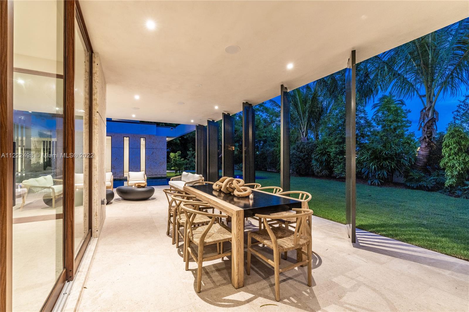 4550 Bay Point Road Miami, FL 33137 - Photo 45 of 92 a patio with yard glass top table and chairs