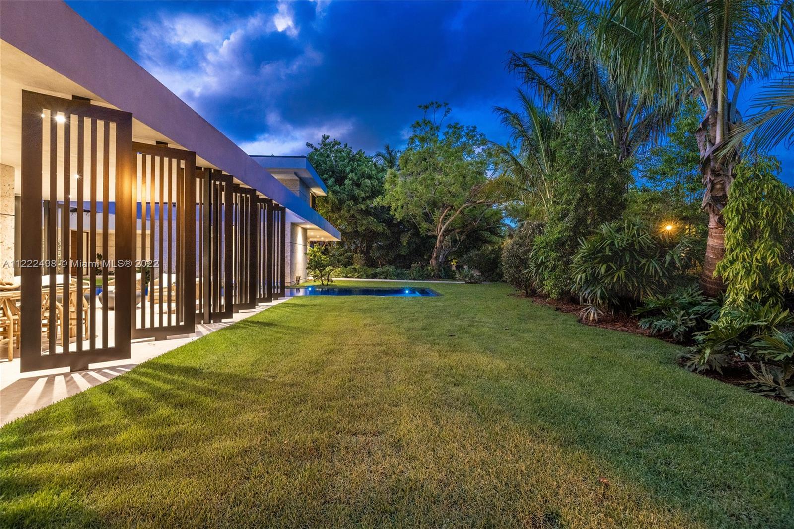 4550 Bay Point Road Miami, FL 33137 - Photo 49 of 92 a swimming pool with wooden fence