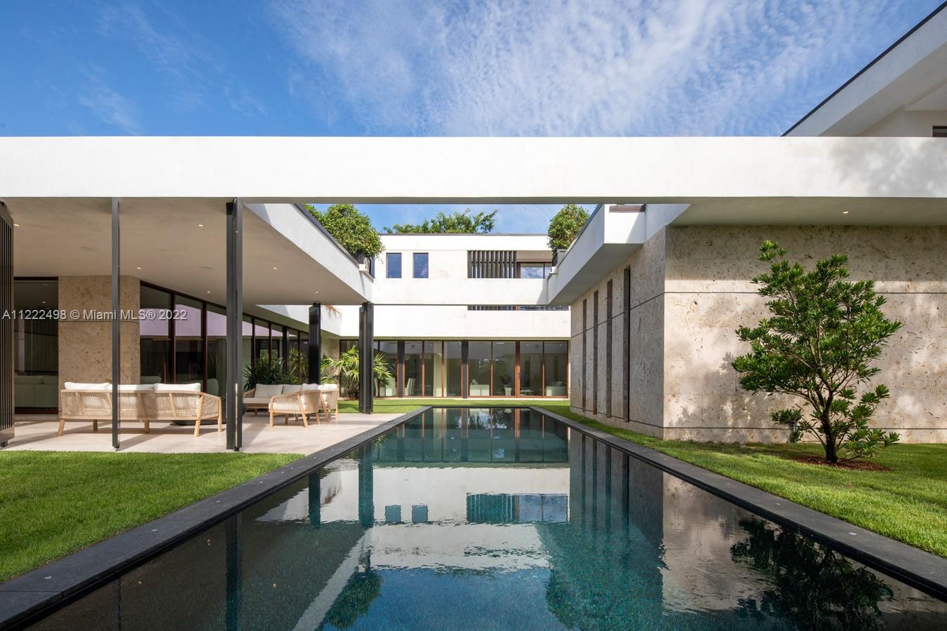 4550 Bay Point Road Miami, FL 33137 - Photo 53 of 92 a view of a swimming pool with a patio and a yard