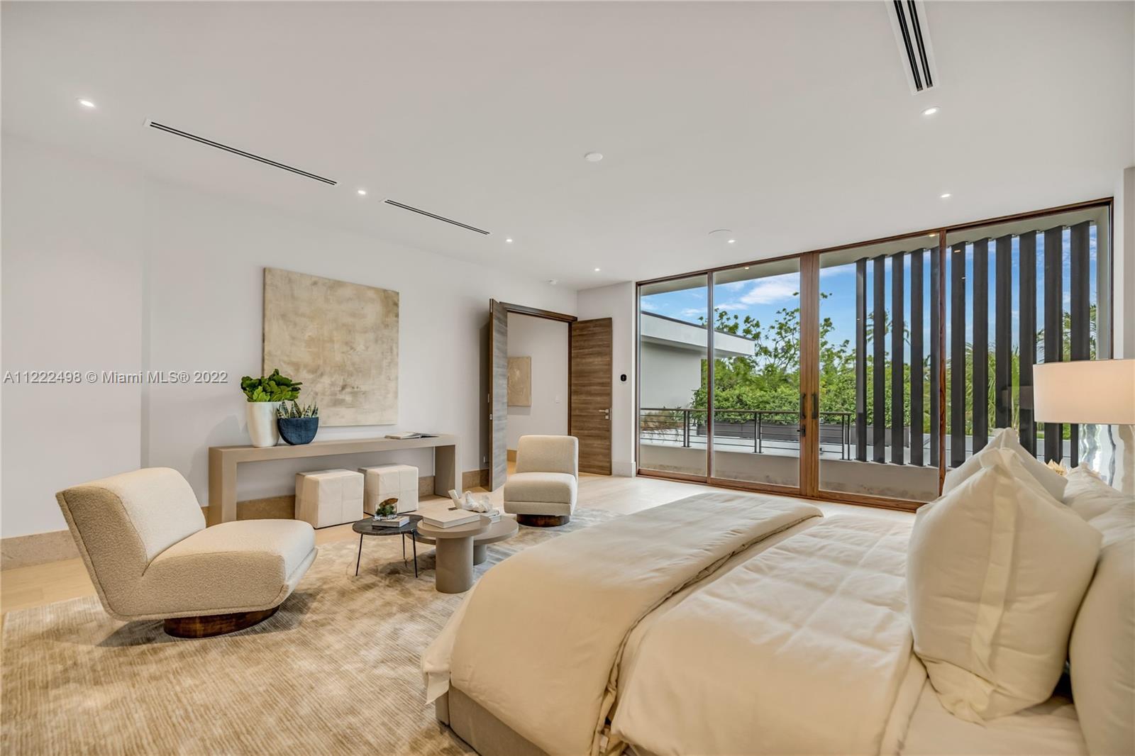 4550 Bay Point Road Miami, FL 33137 - Photo 58 of 92 a spacious bedroom with a bed and a couch