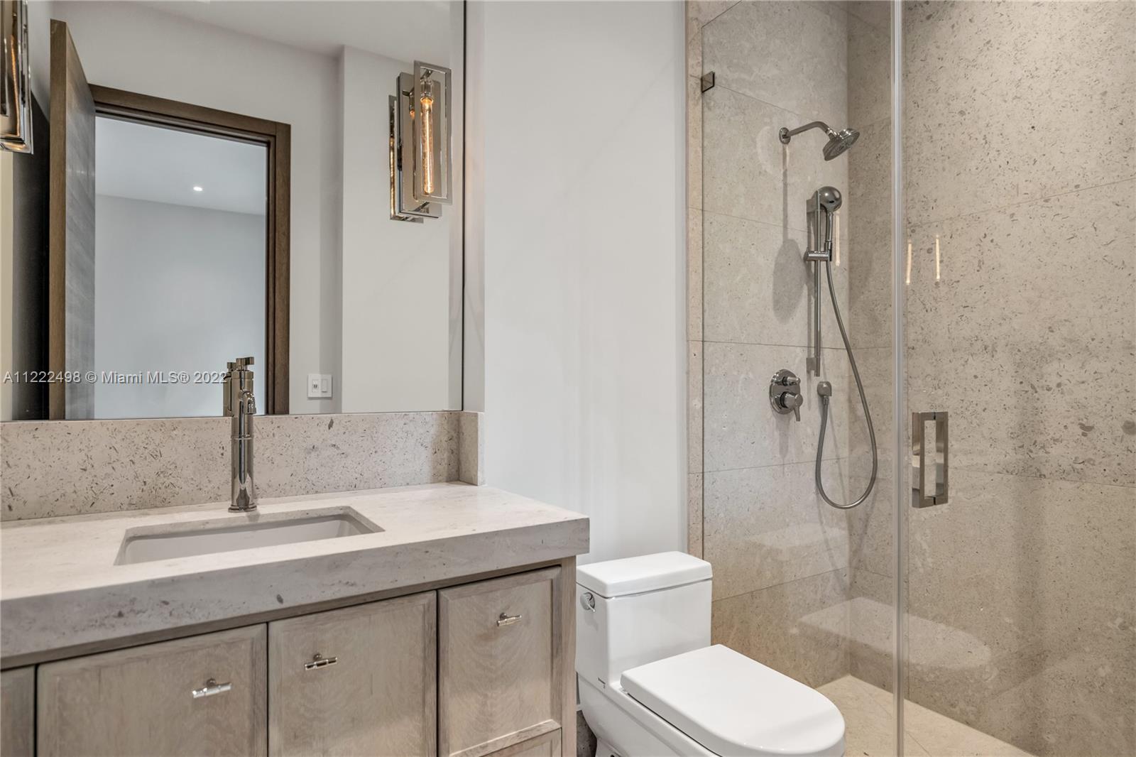 4550 Bay Point Road Miami, FL 33137 - Photo 70 of 92 a bathroom with a granite countertop toilet sink and shower