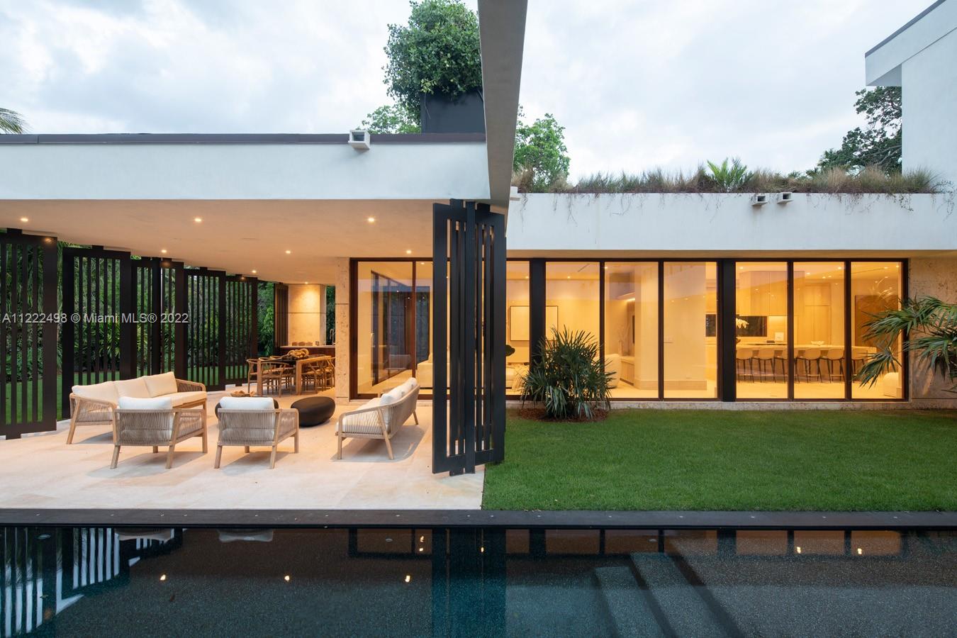 4550 Bay Point Road Miami, FL 33137 - Photo 72 of 92 a view of swimming pool with outdoor seating and plants