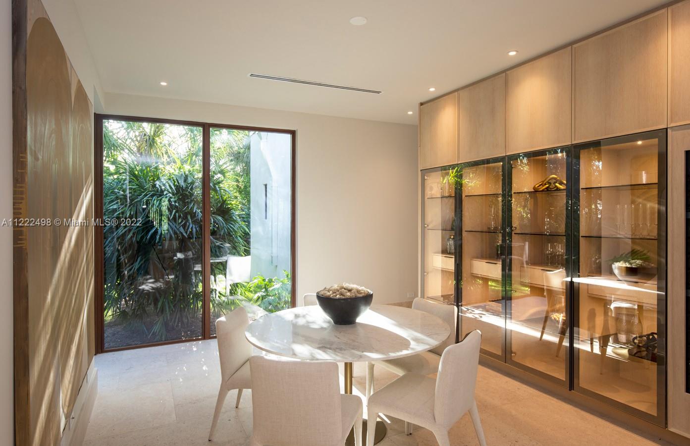 4550 Bay Point Road Miami, FL 33137 - Photo 89 of 92 a dining room with furniture and a floor to ceiling window