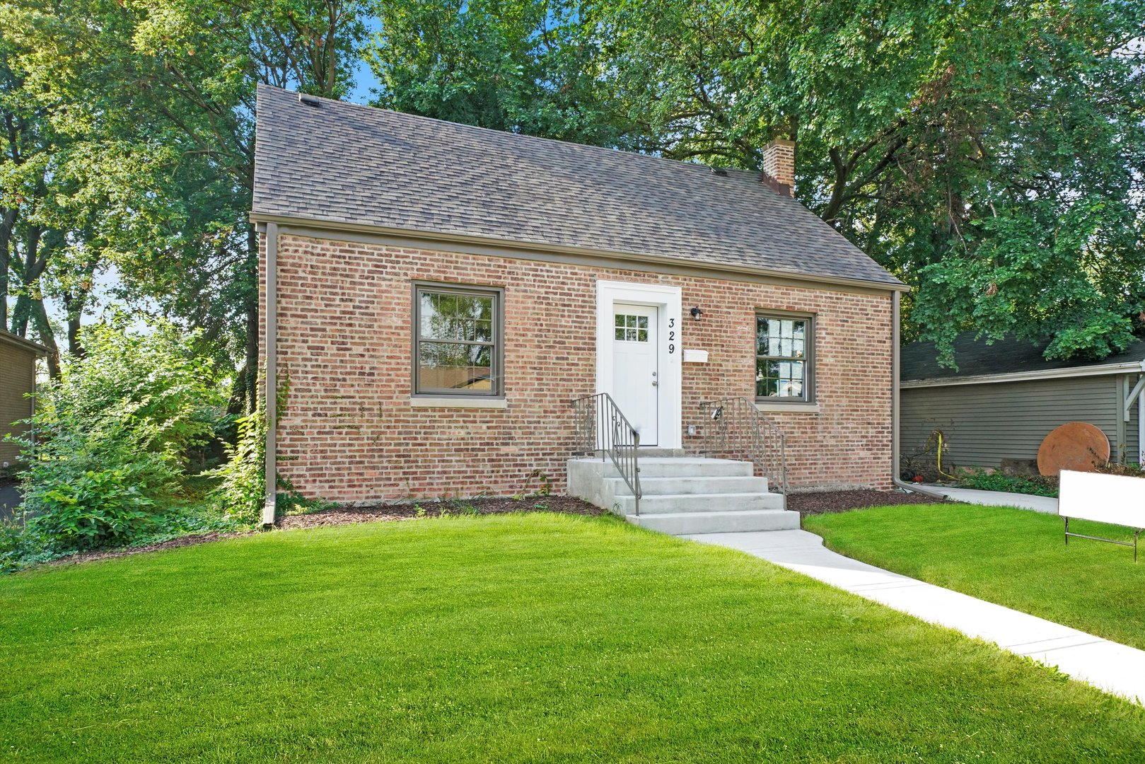 329 East Quincy Street Riverside, IL 60546 - Photo 1 of 39 a front view of a house with a yard
