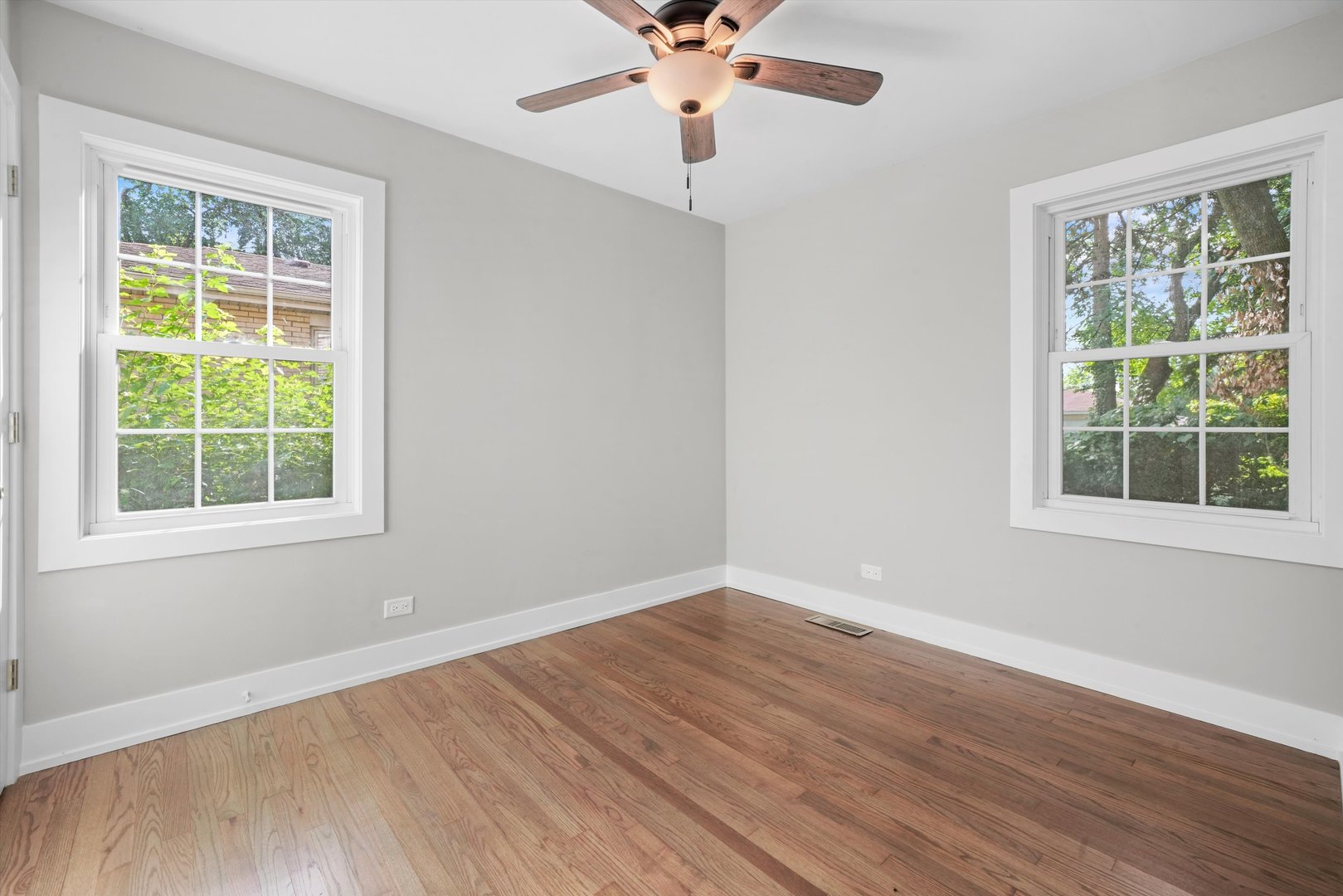 329 East Quincy Street Riverside, IL 60546 - Photo 15 of 39 a view of an empty room with wooden floor and a window