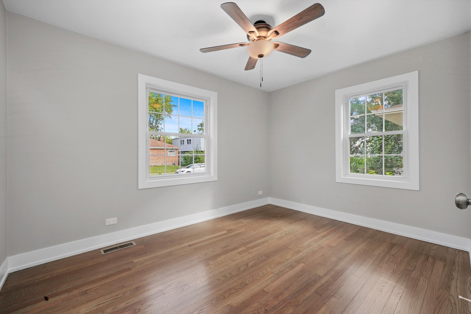 329 East Quincy Street Riverside, IL 60546 - Photo 20 of 39 a view of an empty room with wooden floor and a window