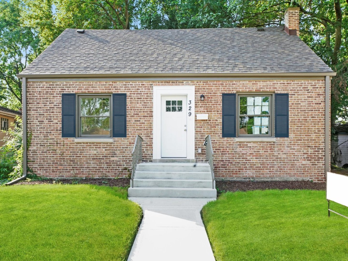 329 East Quincy Street Riverside, IL 60546 - Photo 2 of 39 a front view of a house with a garden