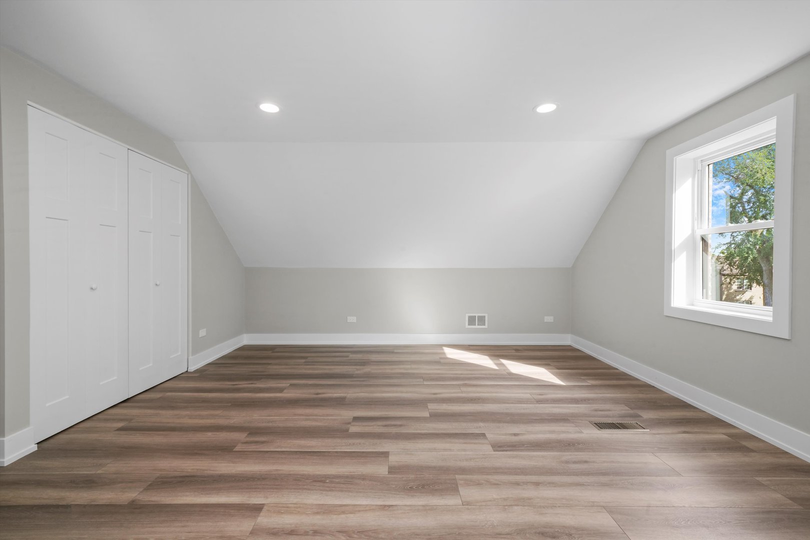 329 East Quincy Street Riverside, IL 60546 - Photo 23 of 39 a view of an empty room with wooden floor and a window