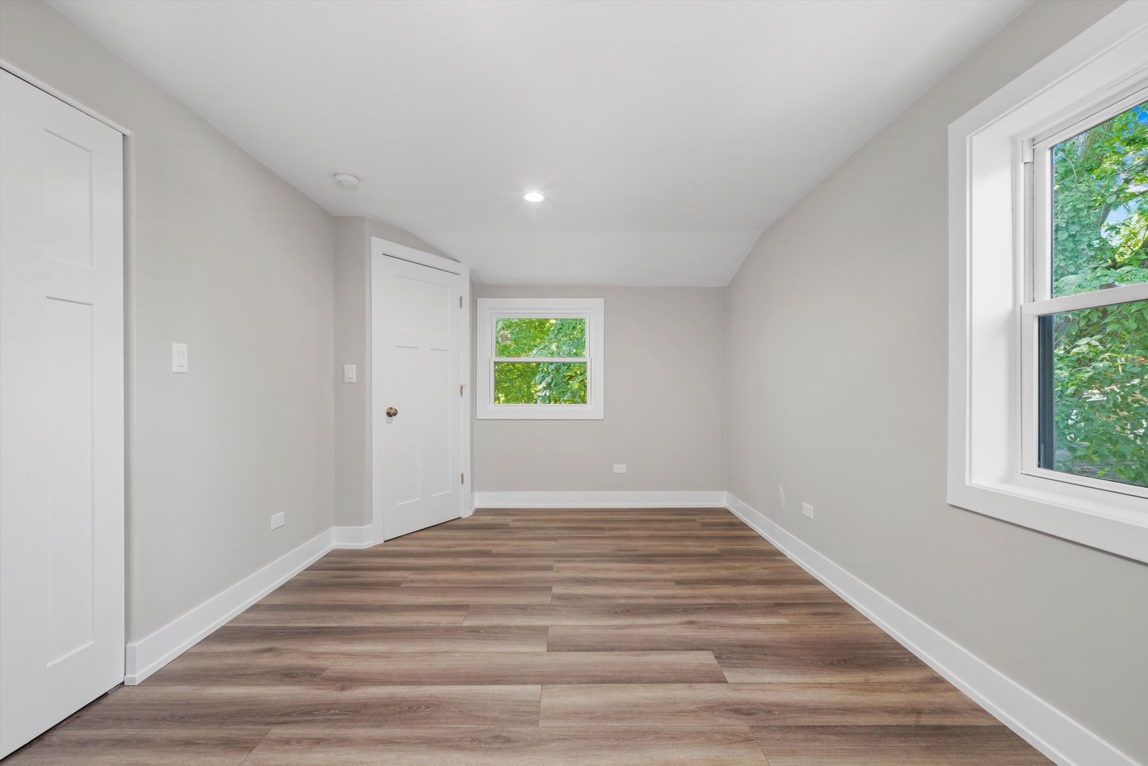 329 East Quincy Street Riverside, IL 60546 - Photo 24 of 39 a view of an empty room with wooden floor and a window