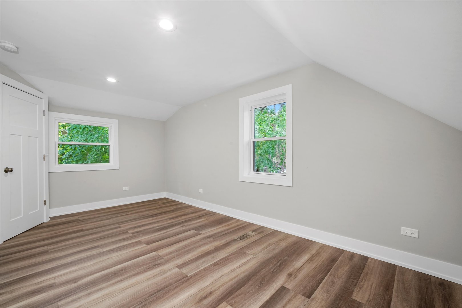 329 East Quincy Street Riverside, IL 60546 - Photo 26 of 39 an empty room with wooden floor and windows