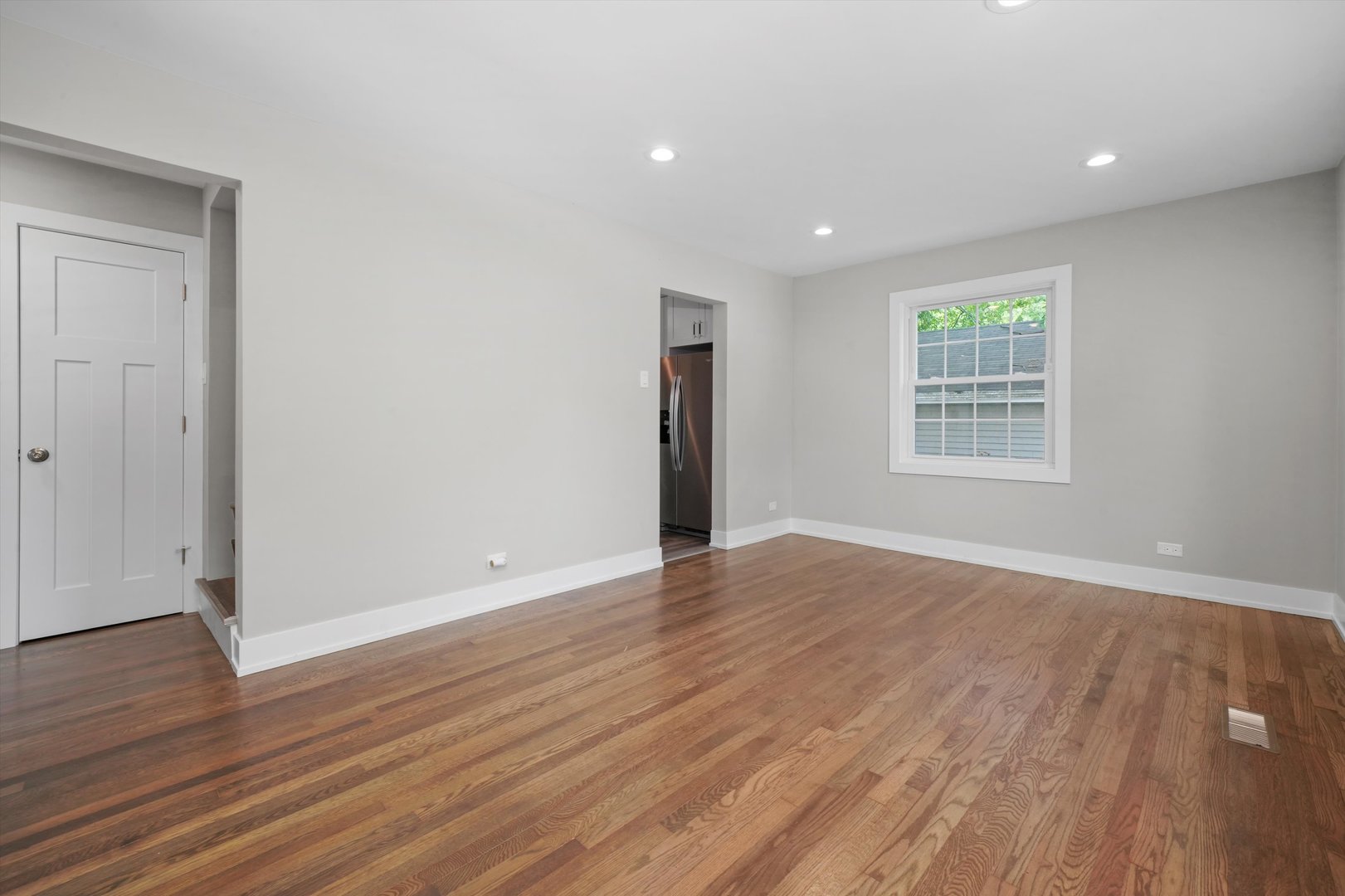 329 East Quincy Street Riverside, IL 60546 - Photo 6 of 39 a view of an empty room with wooden floor and a window