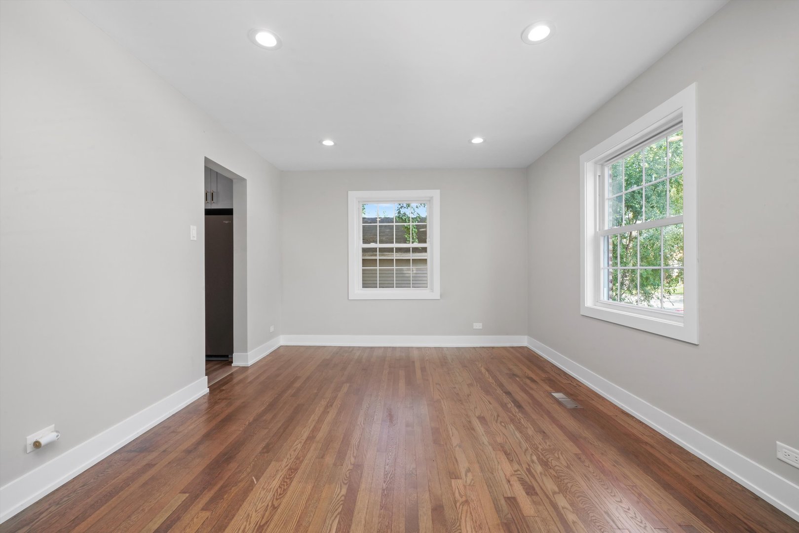 329 East Quincy Street Riverside, IL 60546 - Photo 8 of 39 an empty room with wooden floor and windows