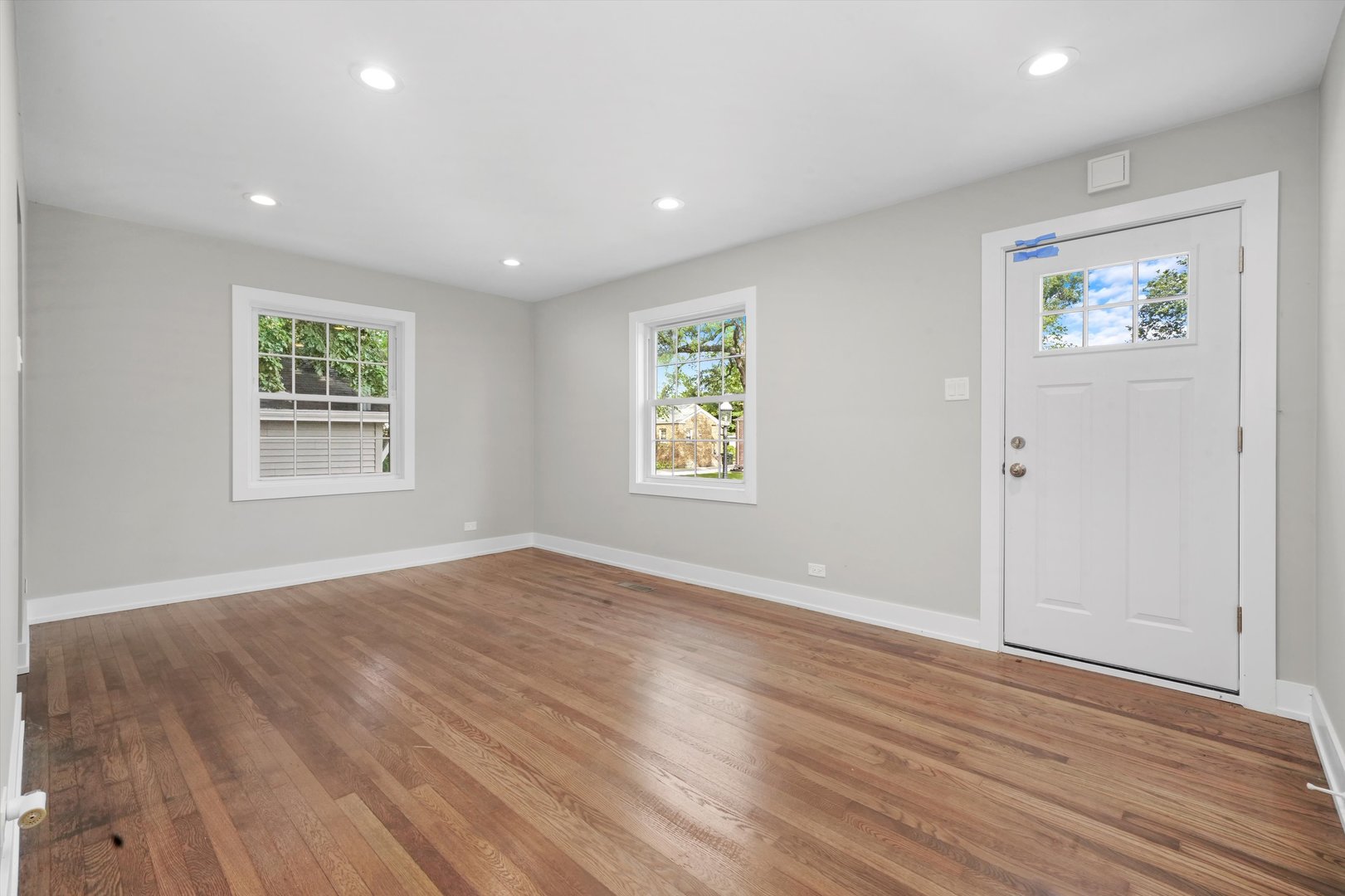 329 East Quincy Street Riverside, IL 60546 - Photo 9 of 39 an empty room with wooden floor and windows