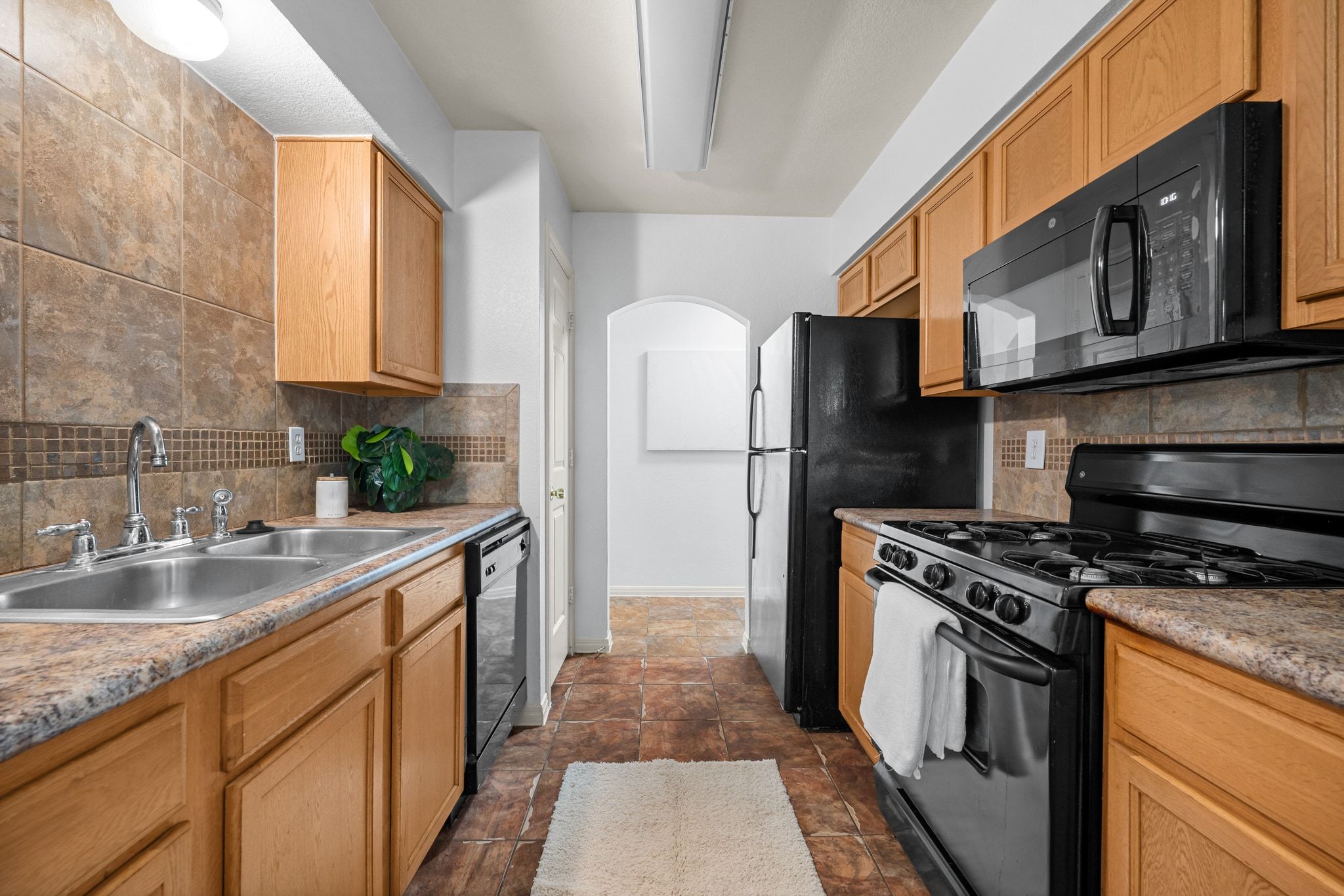 2321 Bendridge Trail Austin, TX 78744 - Photo 14 of 27 a kitchen with stainless steel appliances granite countertop a refrigerator stove and sink