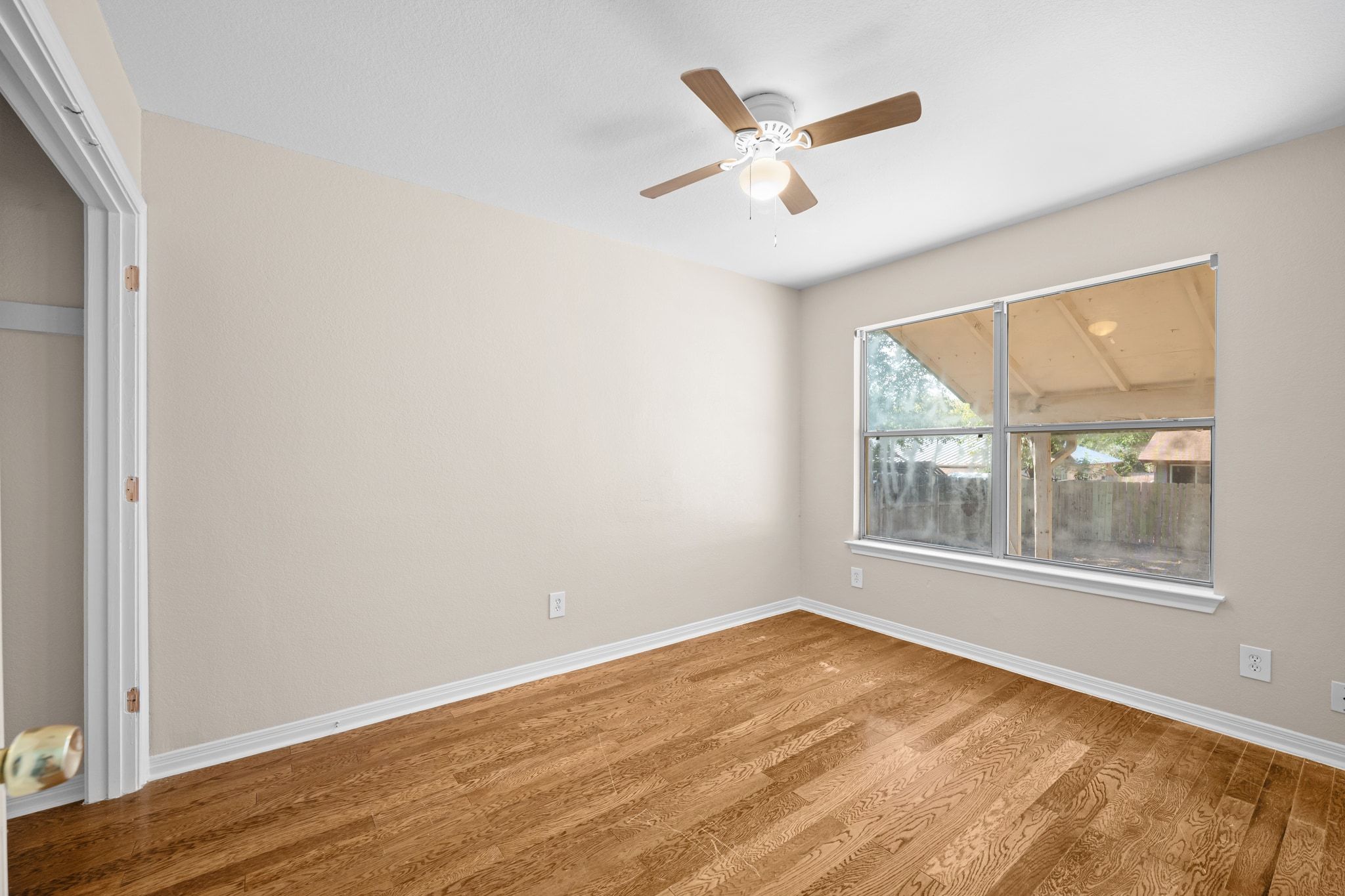 2321 Bendridge Trail Austin, TX 78744 - Photo 20 of 27 an empty room with wooden floor and windows