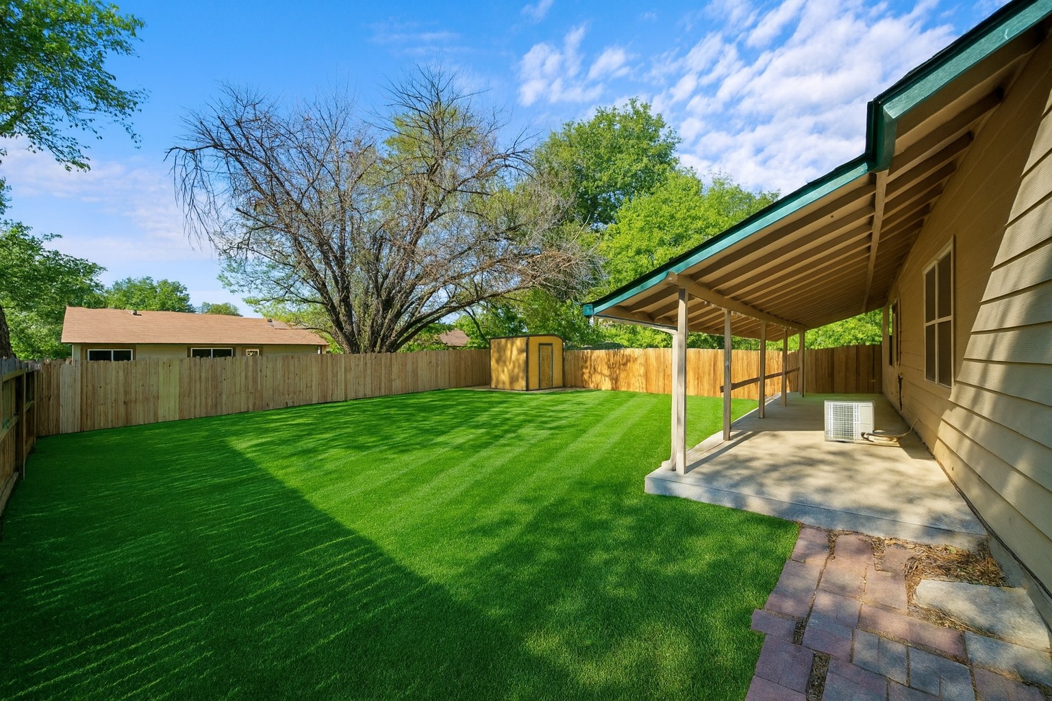 2321 Bendridge Trail Austin, TX 78744 - Photo 25 of 27 a view of a backyard with plants and a backyard