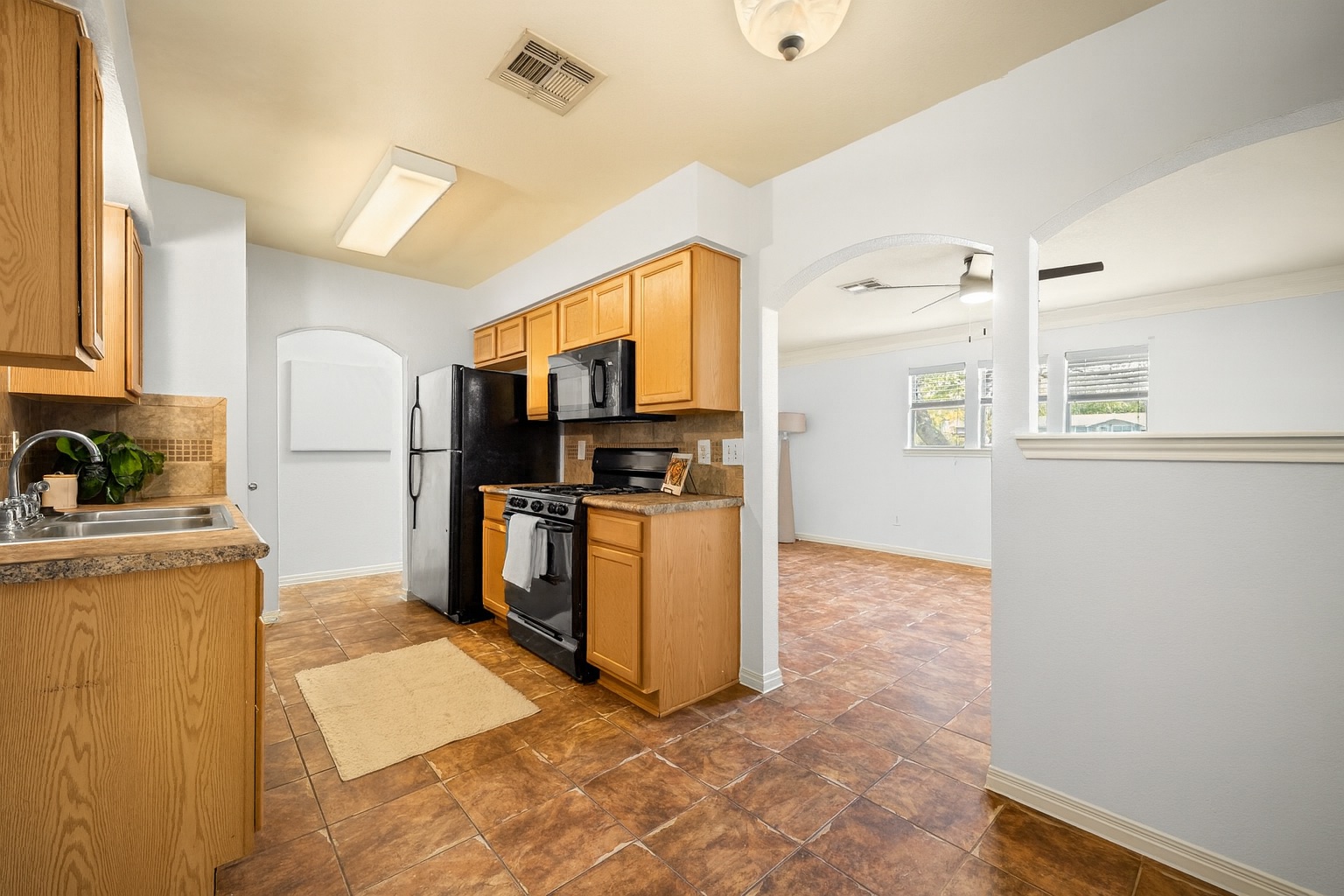 2321 Bendridge Trail Austin, TX 78744 - Photo 4 of 27 a kitchen with refrigerator and cabinets