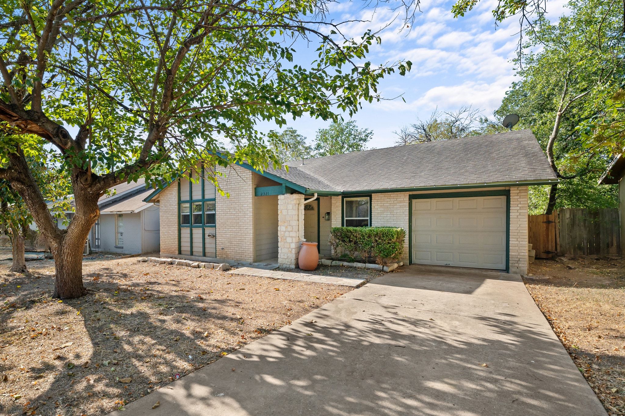 2321 Bendridge Trail Austin, TX 78744 - Photo 8 of 27 a front view of a house with a yard and garage