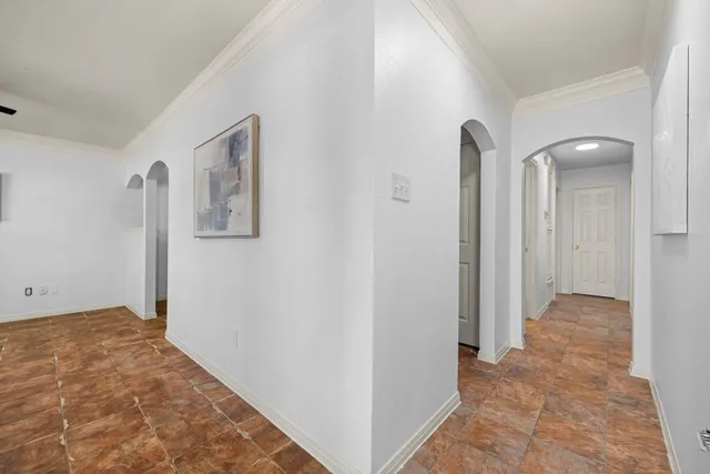 a view of a hallway with wooden floor and closet