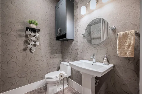 a bathroom with a sink mirror and toilet