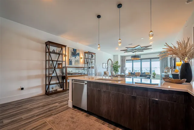 a kitchen with stainless steel appliances granite countertop a sink and wooden cabinets