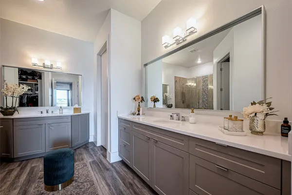a spacious bathroom with a granite countertop sink a mirror and bathtub