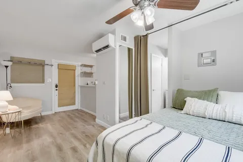 a bedroom with a bed and a chandelier