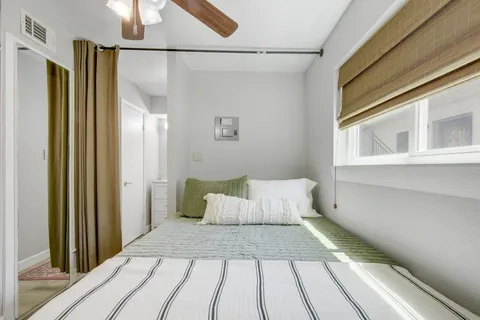 a bedroom with a bed and a window