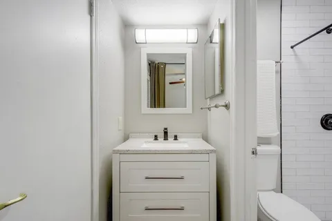 a bathroom with a sink toilet and shower