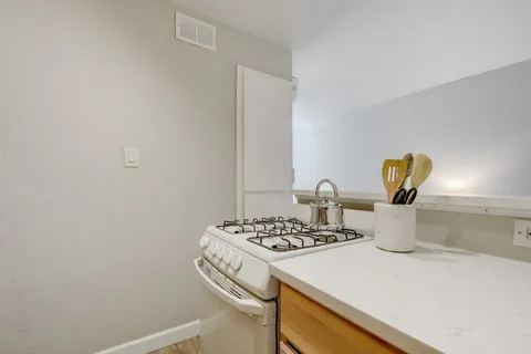 a kitchen with a sink cabinets and stove