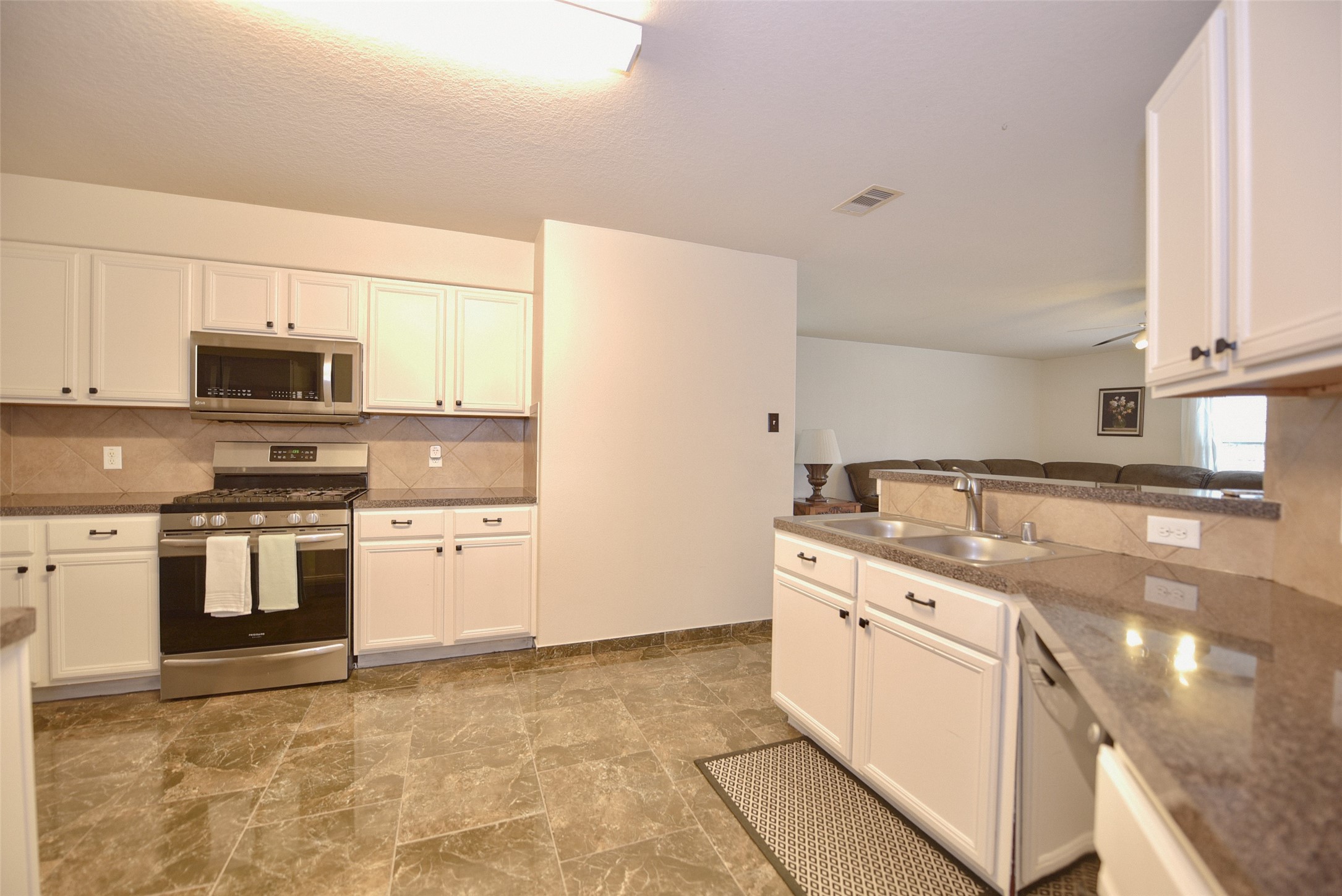 2719 Magnolia Hill Trail Houston, TX 77038 - Photo 19 of 28 a kitchen with stainless steel appliances granite countertop a sink and a stove