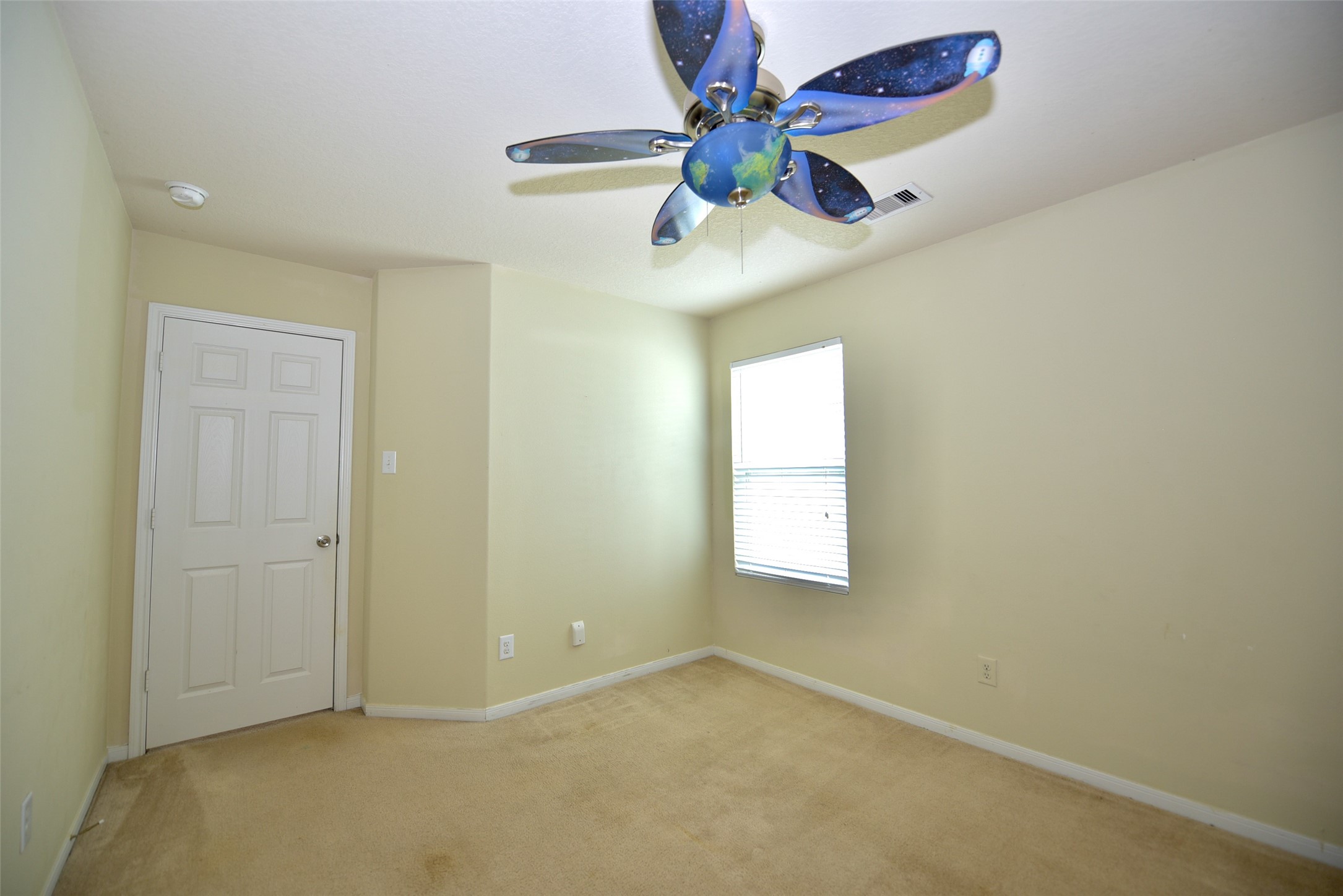 2719 Magnolia Hill Trail Houston, TX 77038 - Photo 7 of 28 an empty room with windows and fan