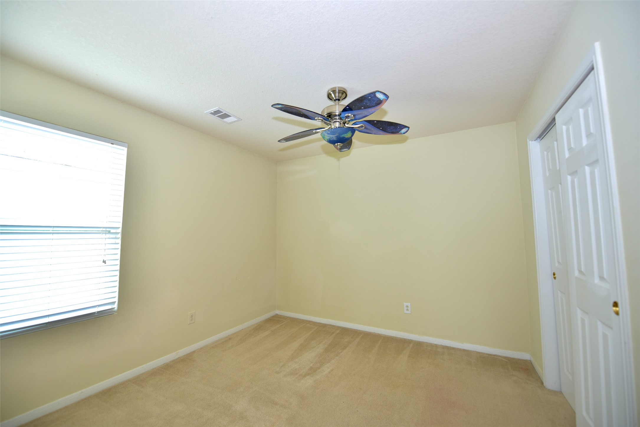 2719 Magnolia Hill Trail Houston, TX 77038 - Photo 10 of 28 an empty room with a window and a fan
